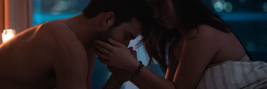 A couple resting in a dimly lit bedroom at night